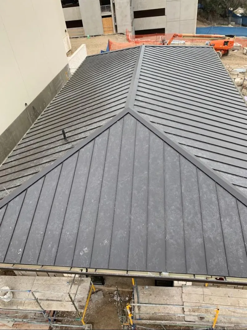 Commercial metal roof construction with crane equipment in North Mankato