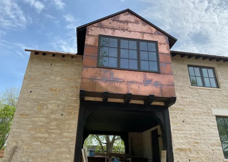 Copper metal panel facade on a stone building for Skylight Installation in North Mankato